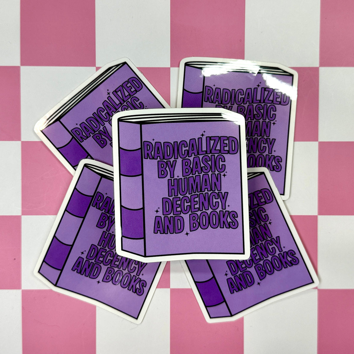 Purple book-shaped stickers with text on a pink and white checkered background